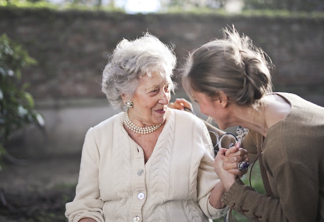 בחורה מדברת ברכות עם אישה זקנה